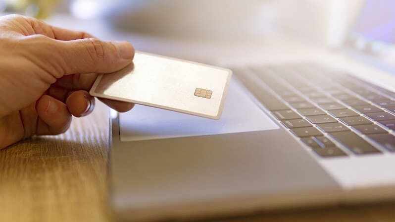 a debit card and a laptop used to buy from a dropshipping business